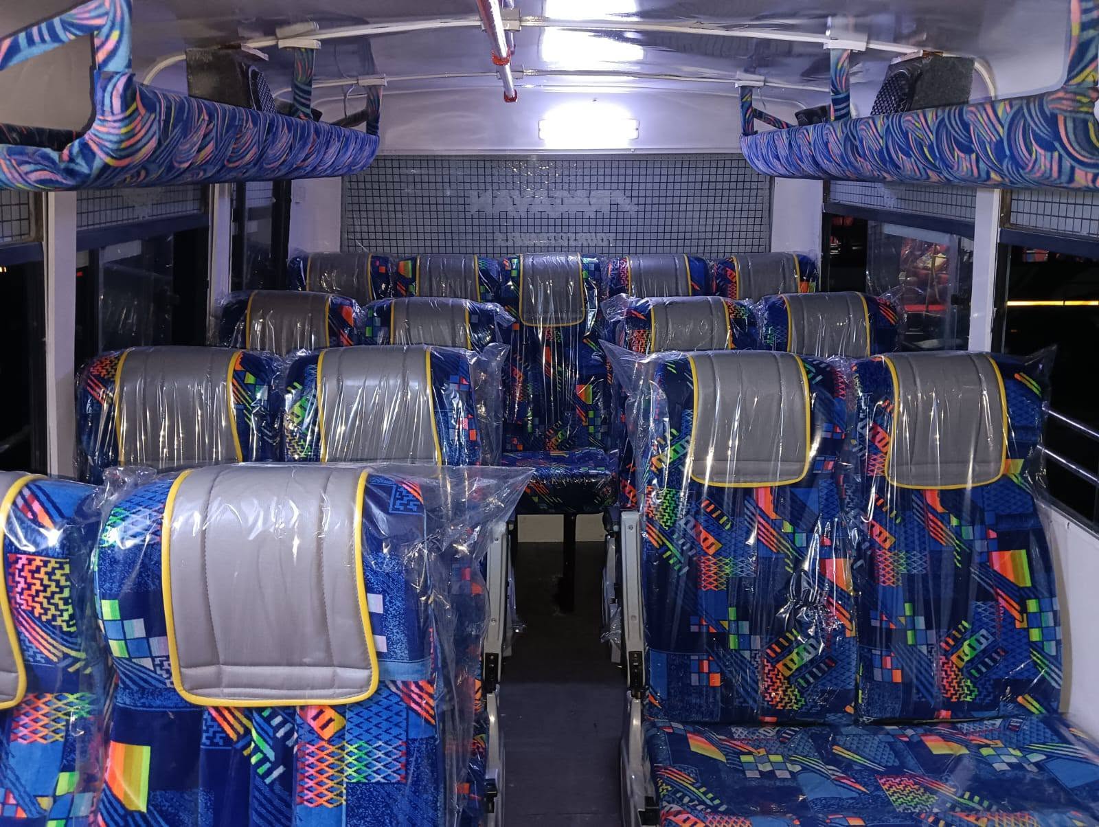 Full bus interior with colourful patterned seats