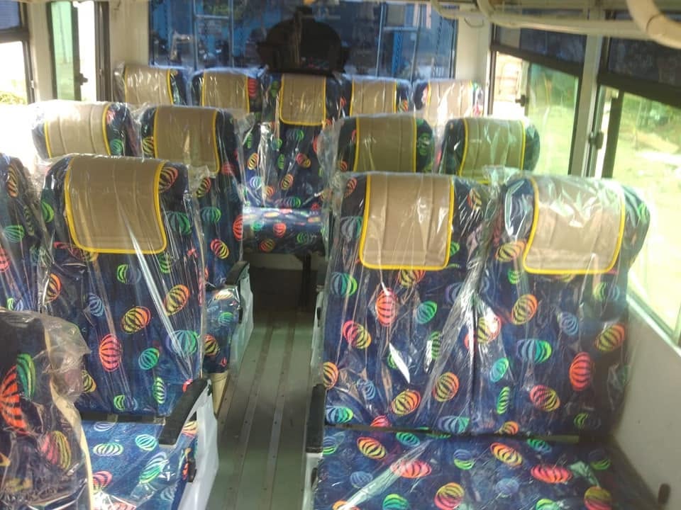 Bright daytime bus interior with colourful seats
