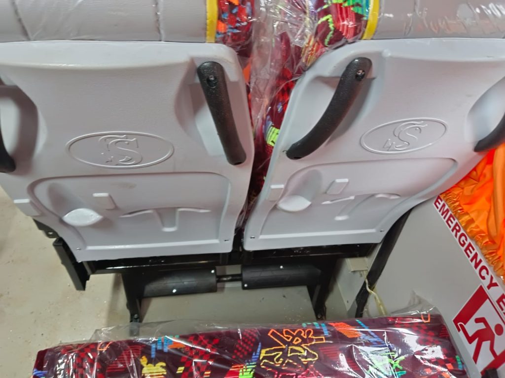 Installed coach seats with emergency exit signage