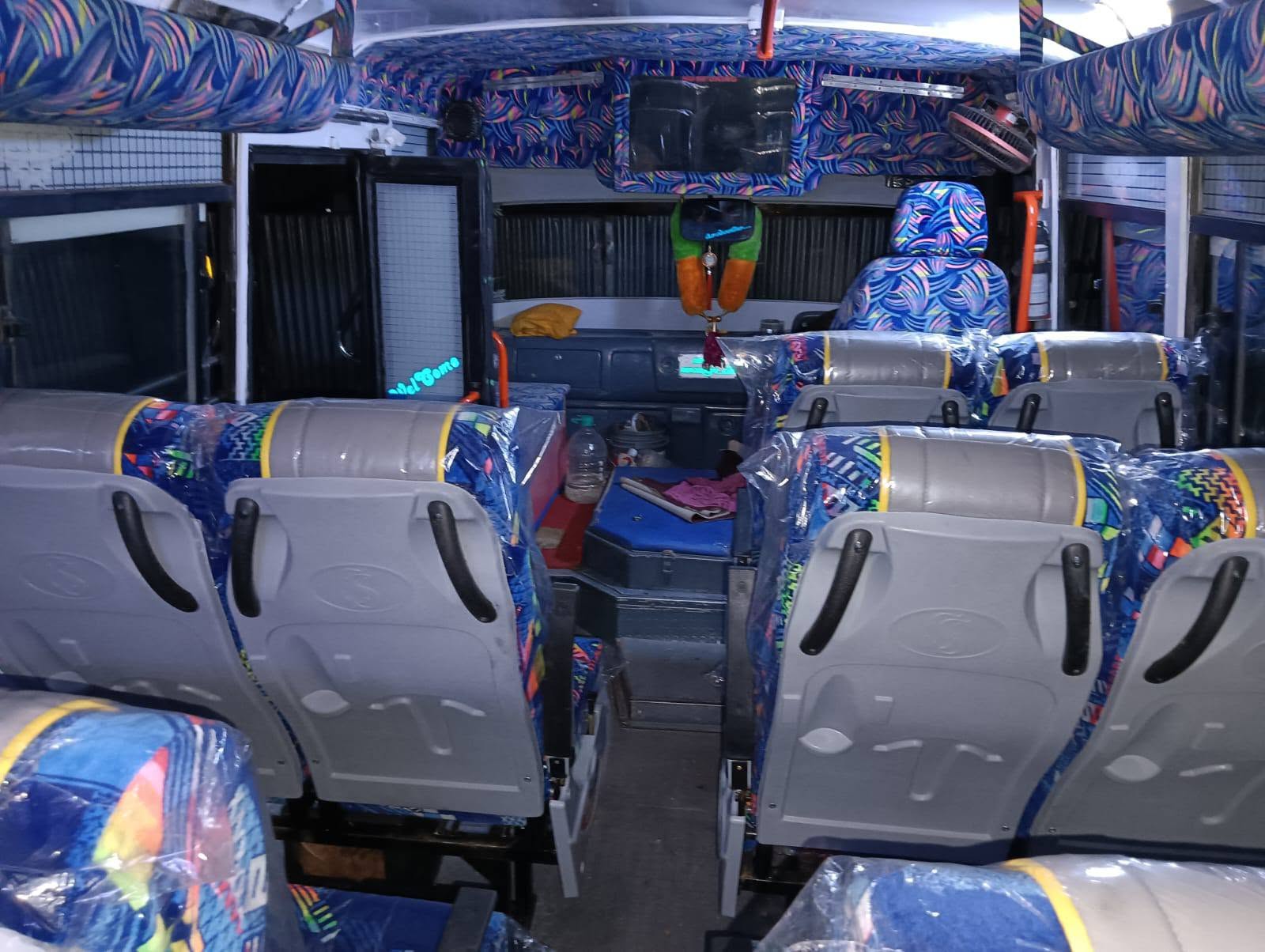 Full bus interior with driver area and patterned seats
