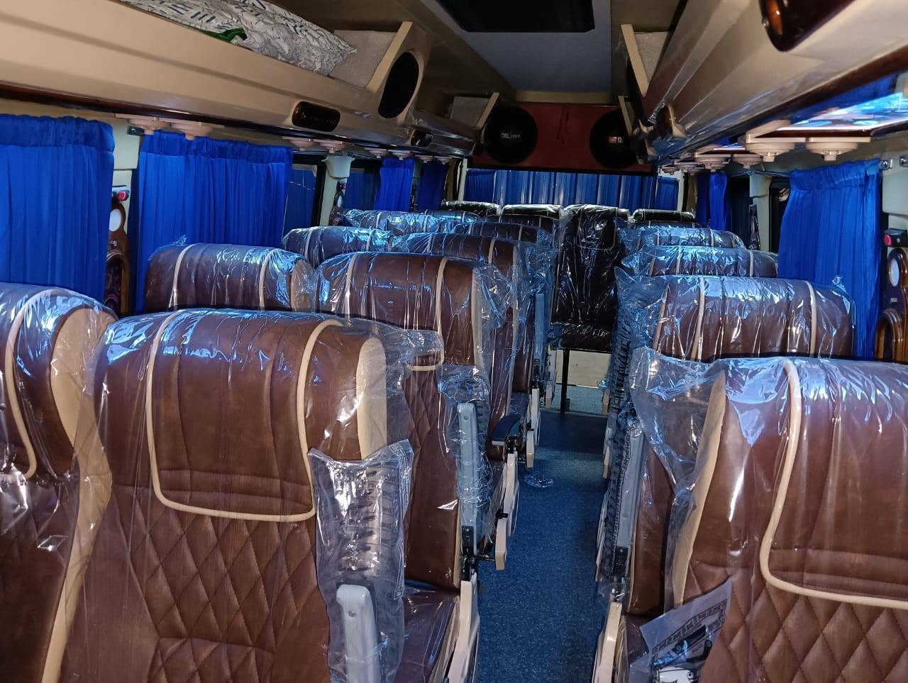 Wide view of brown diamond-quilted seats with blue curtains