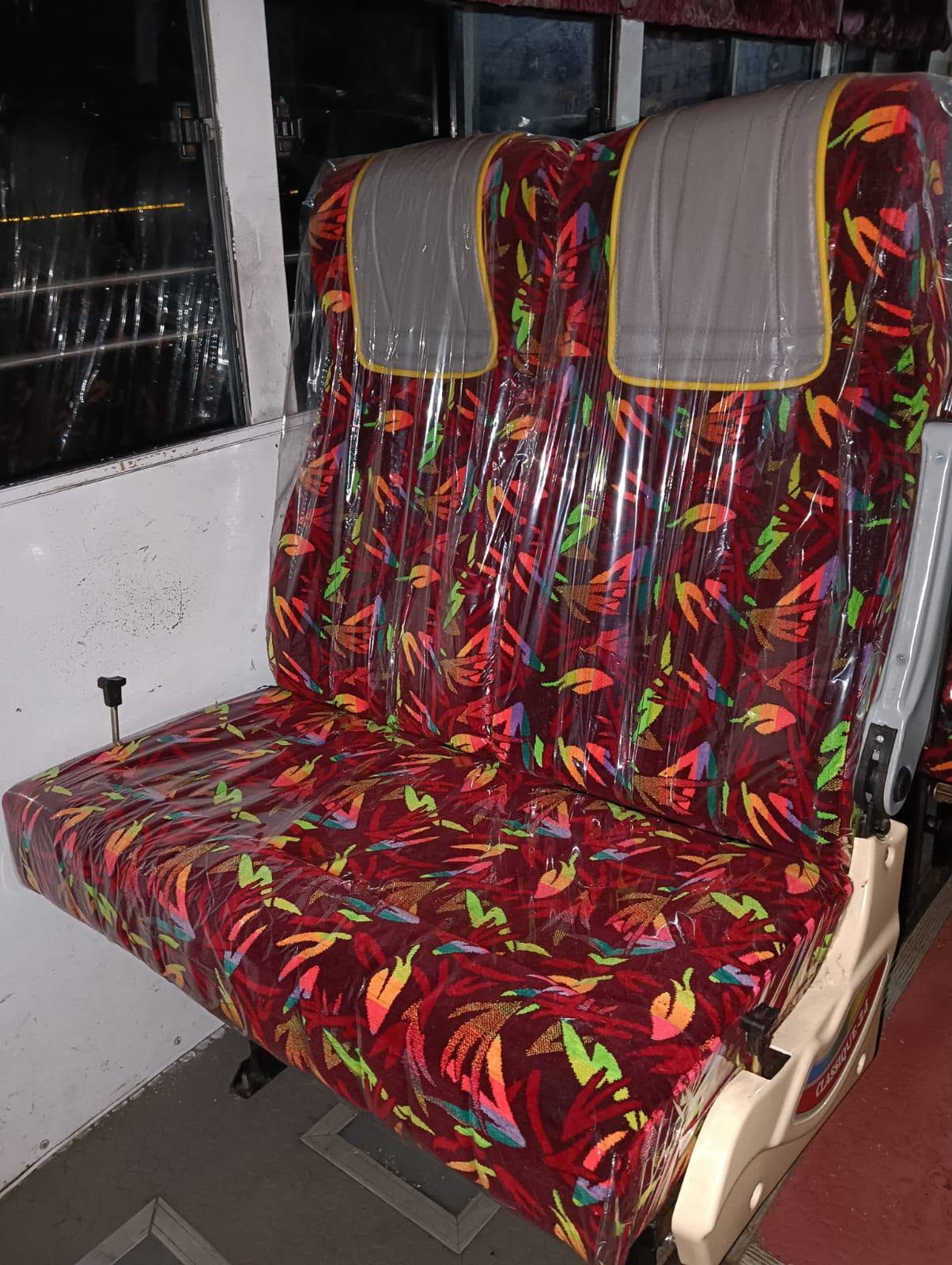 Dark red floral patterned push-back seat