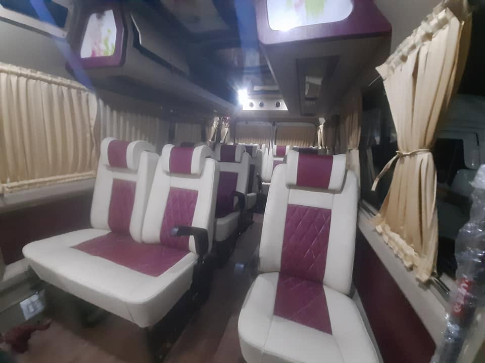 Luxury maroon and white captain seats with curtains