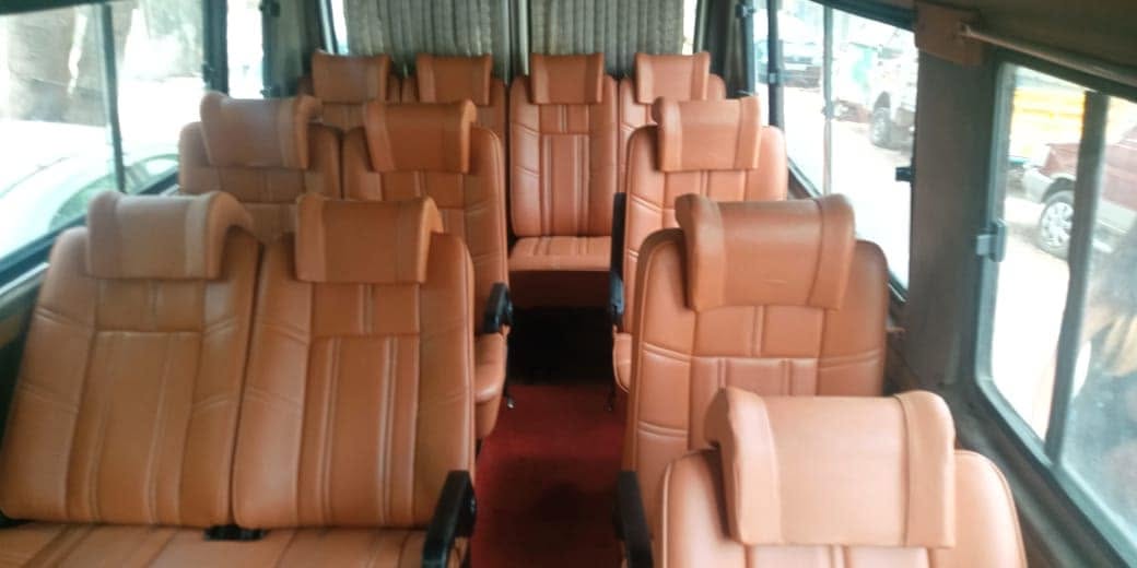Tan leather seats with red carpet aisle