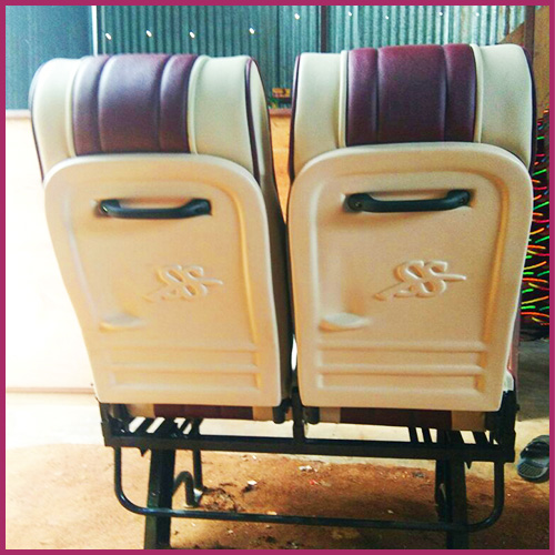Maroon and cream push-back seat pair with embossed logo