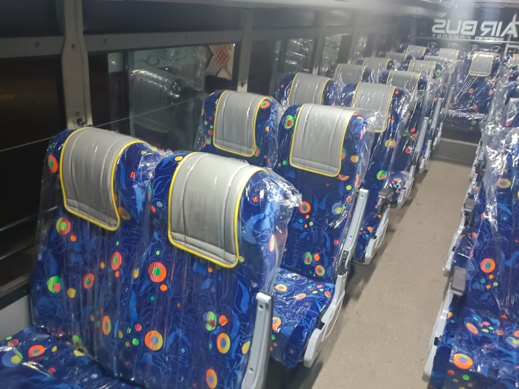 Finished bus interior with patterned seats and Air Bus branding